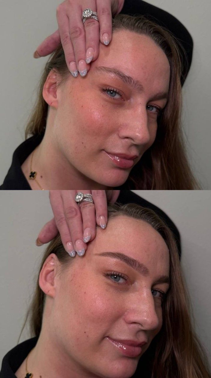 Woman with light makeup, hand on forehead. Smiling, against a plain background.