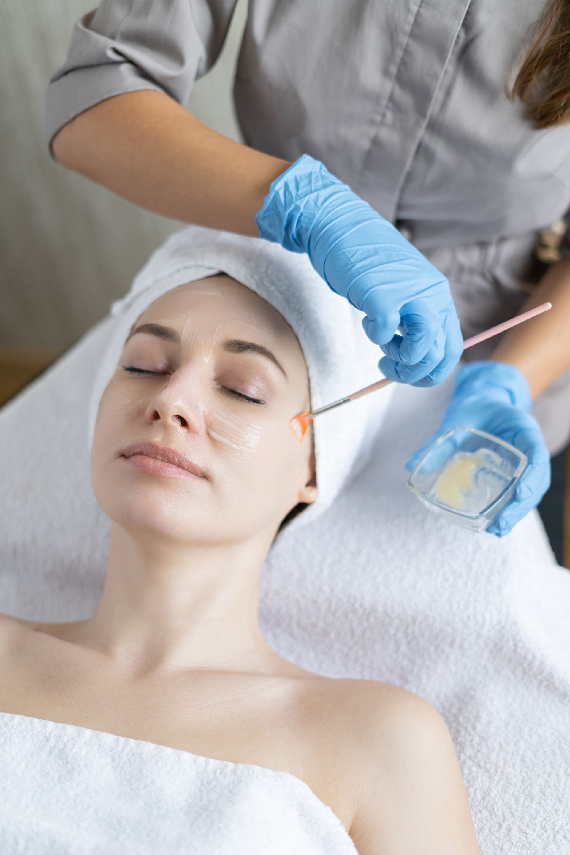 A woman is getting a facial treatment at a spa.