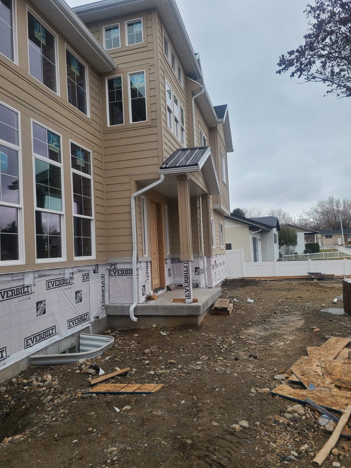 A man is standing on the roof of a house.