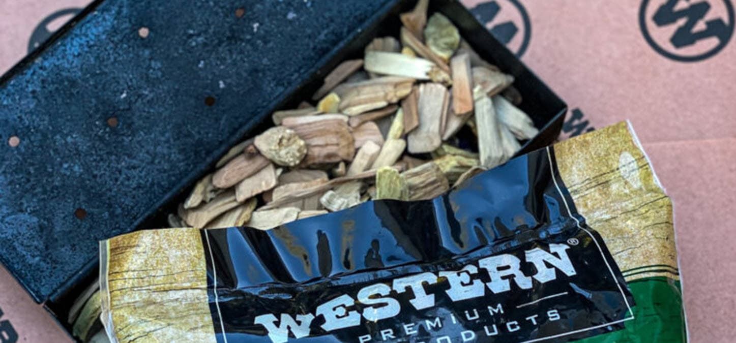 A close up of a fire with wood chips and charcoal.