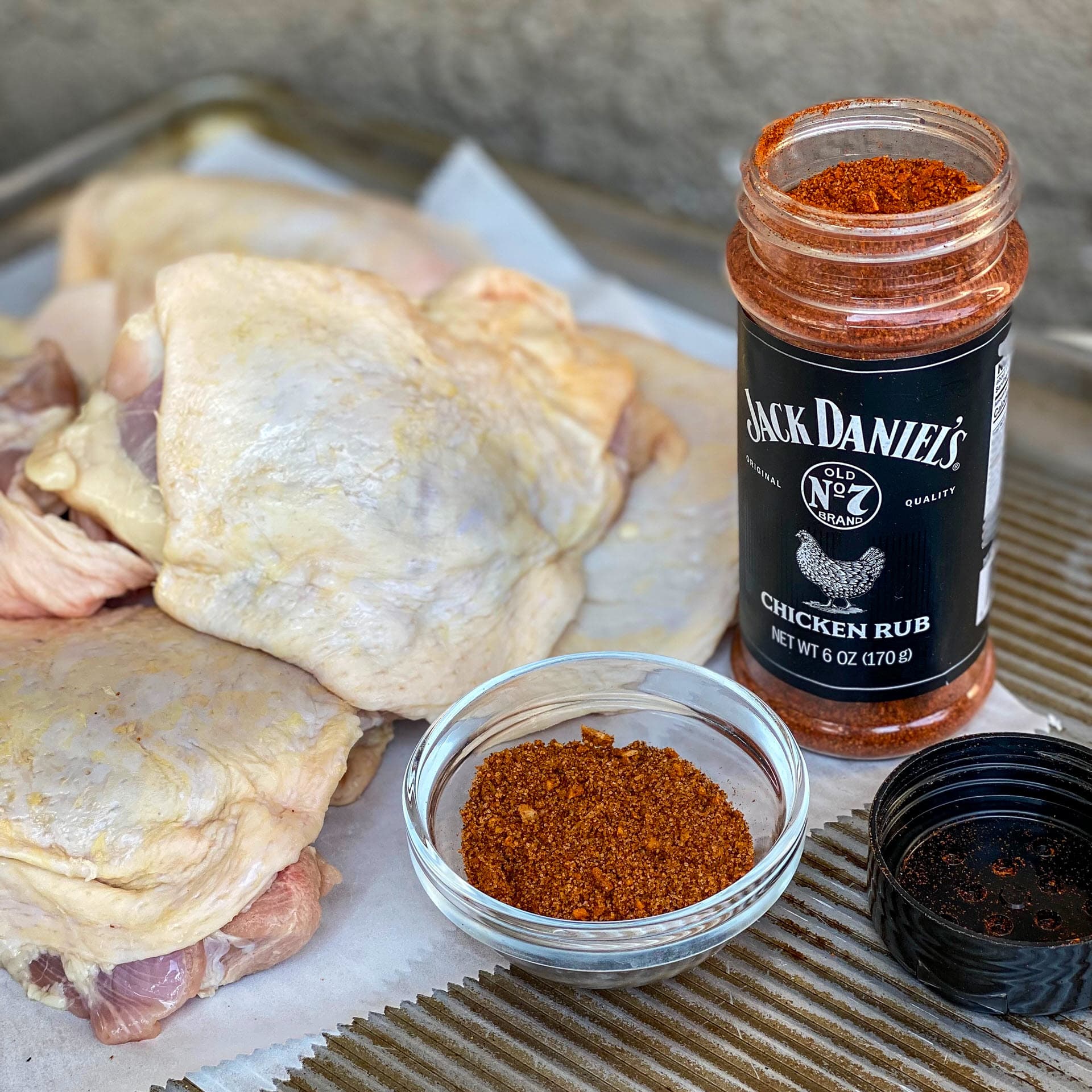 uncooked Chicken thighs with jack daniel's chicken rub