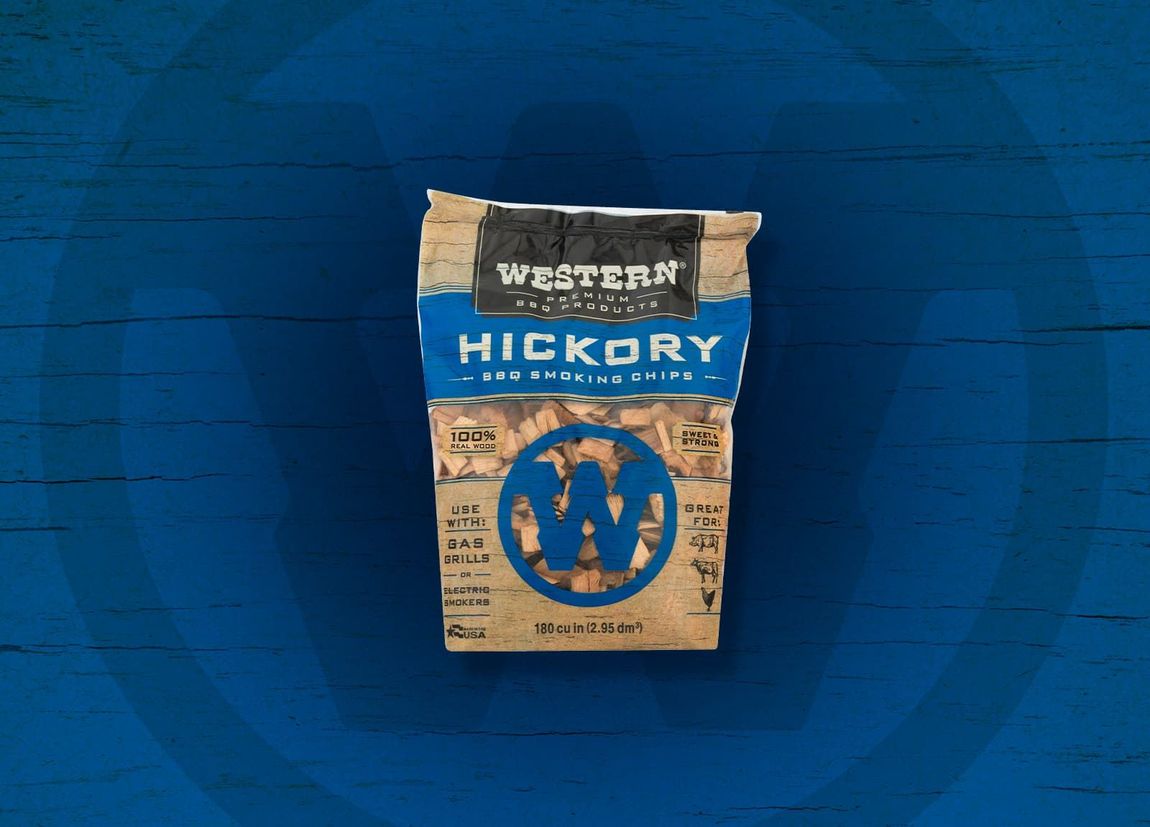 Bag of Western Hickory BBQ wood chips on a blue surface.