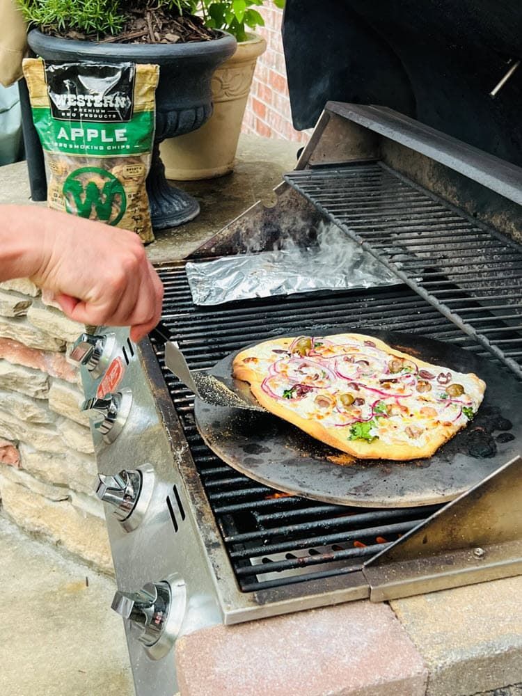 Greek Veggie Smoked Pizza cooking on a gas grill with apple smoking chips