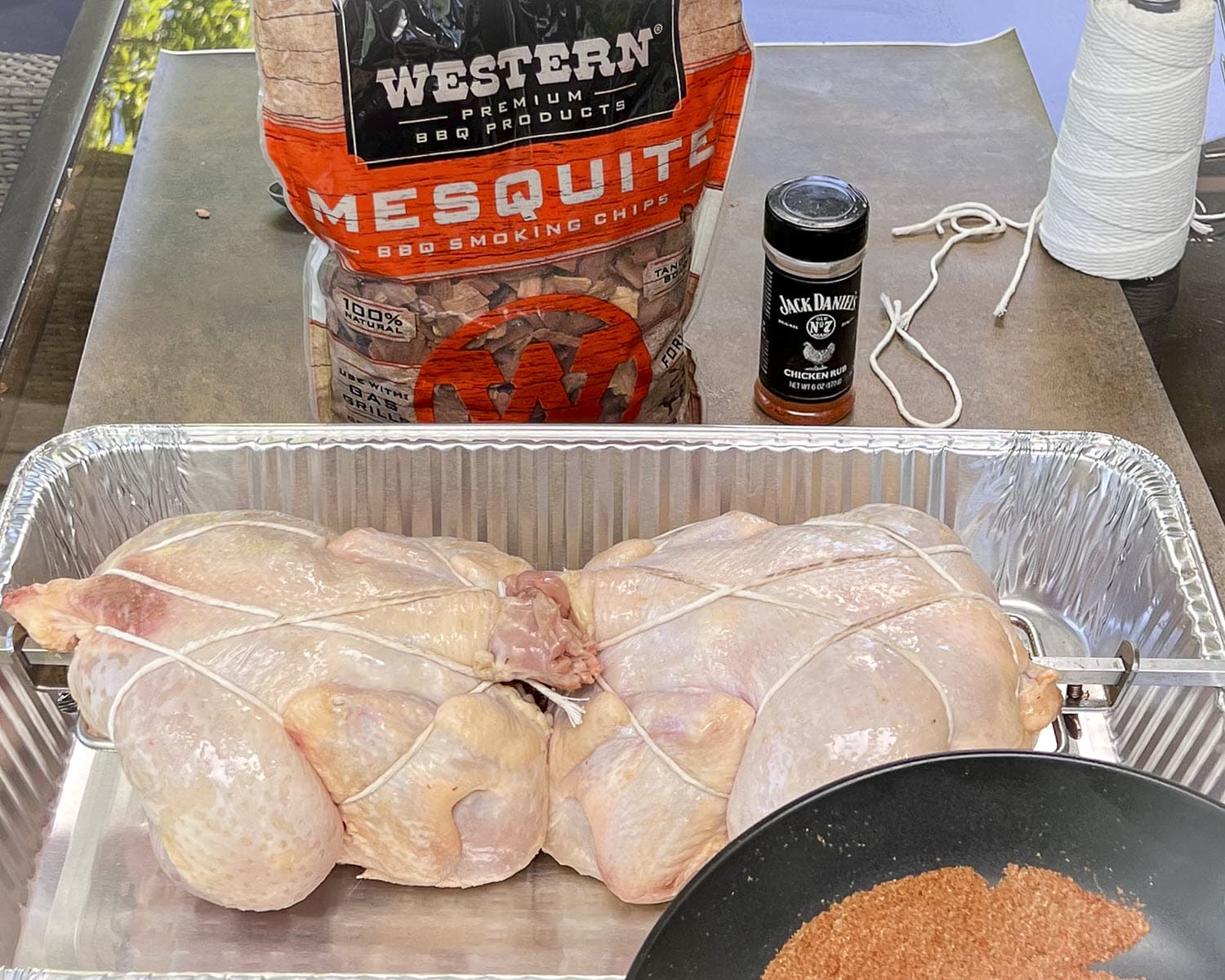 Western Mesquite Smoking Chips bag, Jack Daniel's Chicken rub string and whole chickens