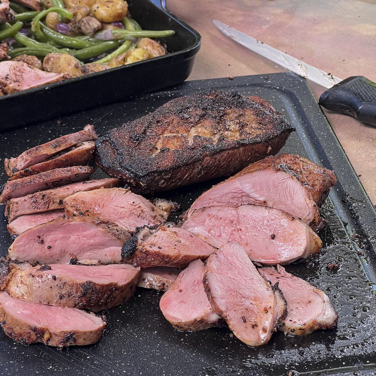 duck breast sliced and whole charred on the grill