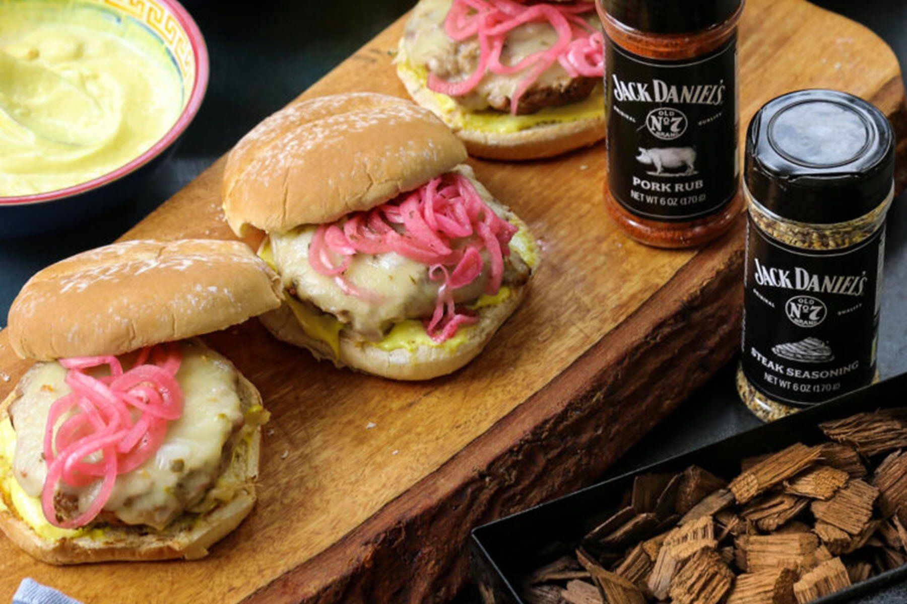 Pork Burgers with cheese and pickled onions, aoili, Jack Daniels Steak Seasoning and Pork rub, and Jack Daniel's whiskey barrel smoking chips in a smoker box