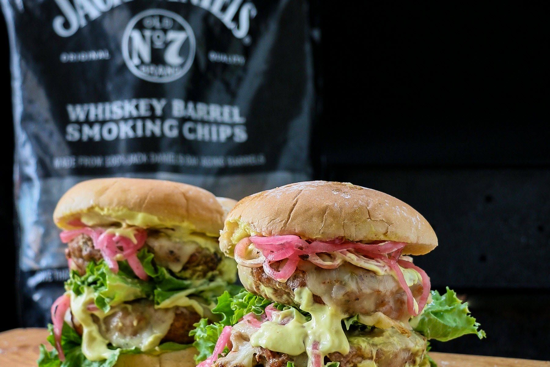 Pork Burgers with Jack Daniels Whiskey Barrel Smoking Chips back in  background