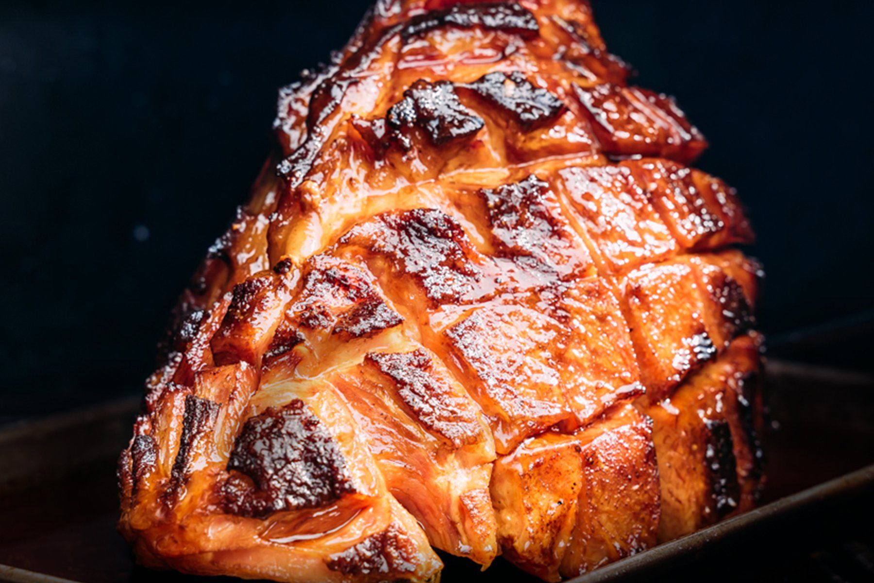Close up of scored, barbecued Glazed Ham