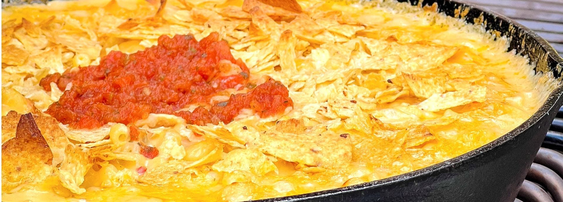 Smoked Cheesy baked casserole in a skillet, topped with salsa