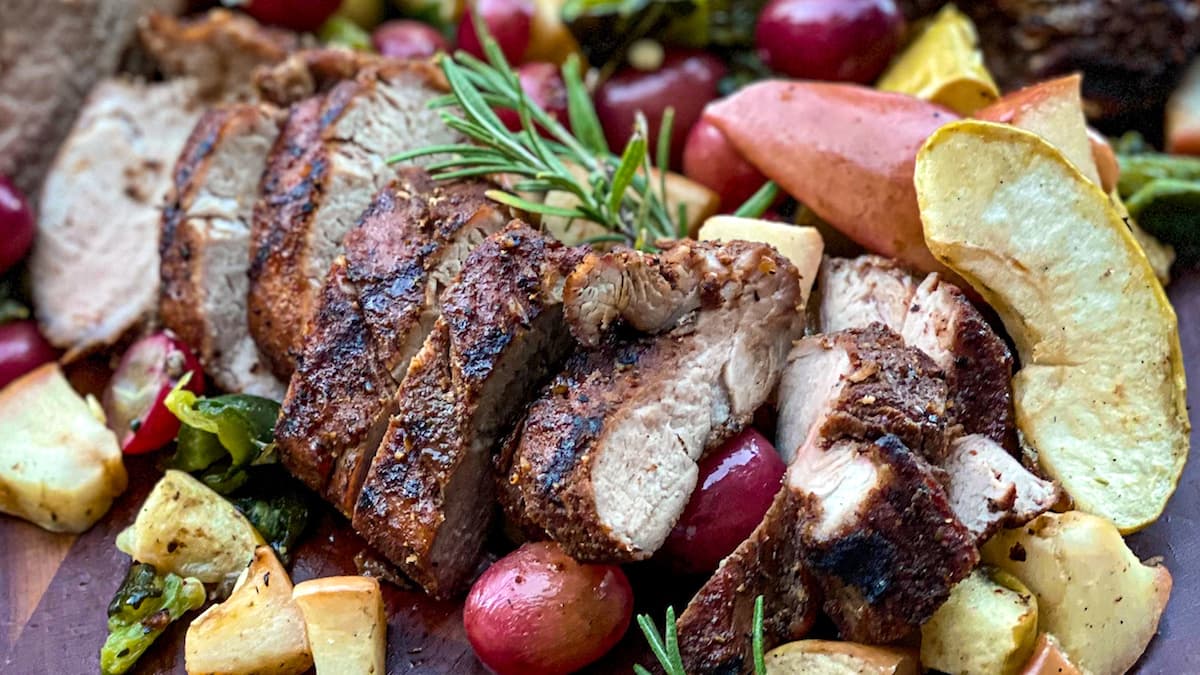 Grilled, smoked pork tenderloin with glazed fruit and rosemary