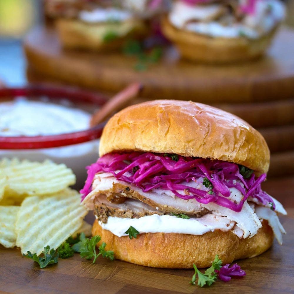 Hickory Smoked Pork Loin Sandwich with red cabbage, onions, horseradish sauce and potato chips