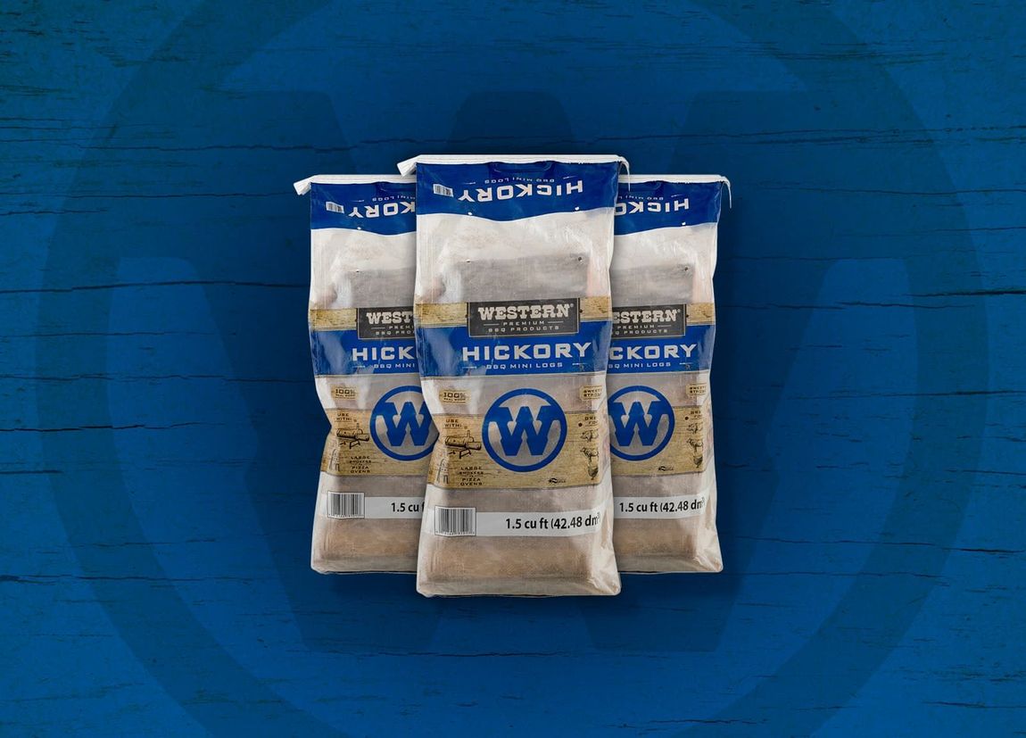 Three bags of Western Hickory bbq mini logs on a blue background. 