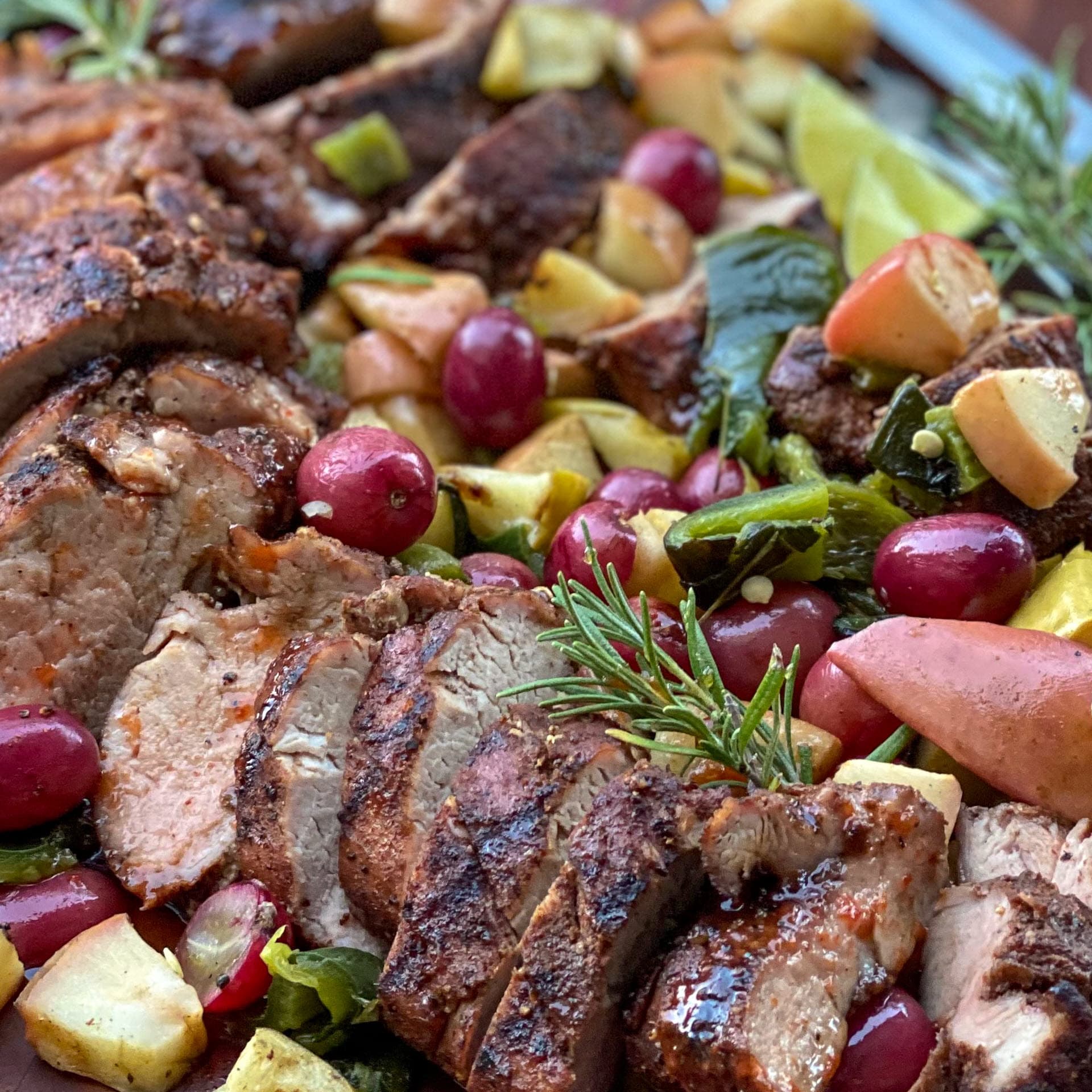 smoked pork tenderloin sliced with grilled apples and grapes