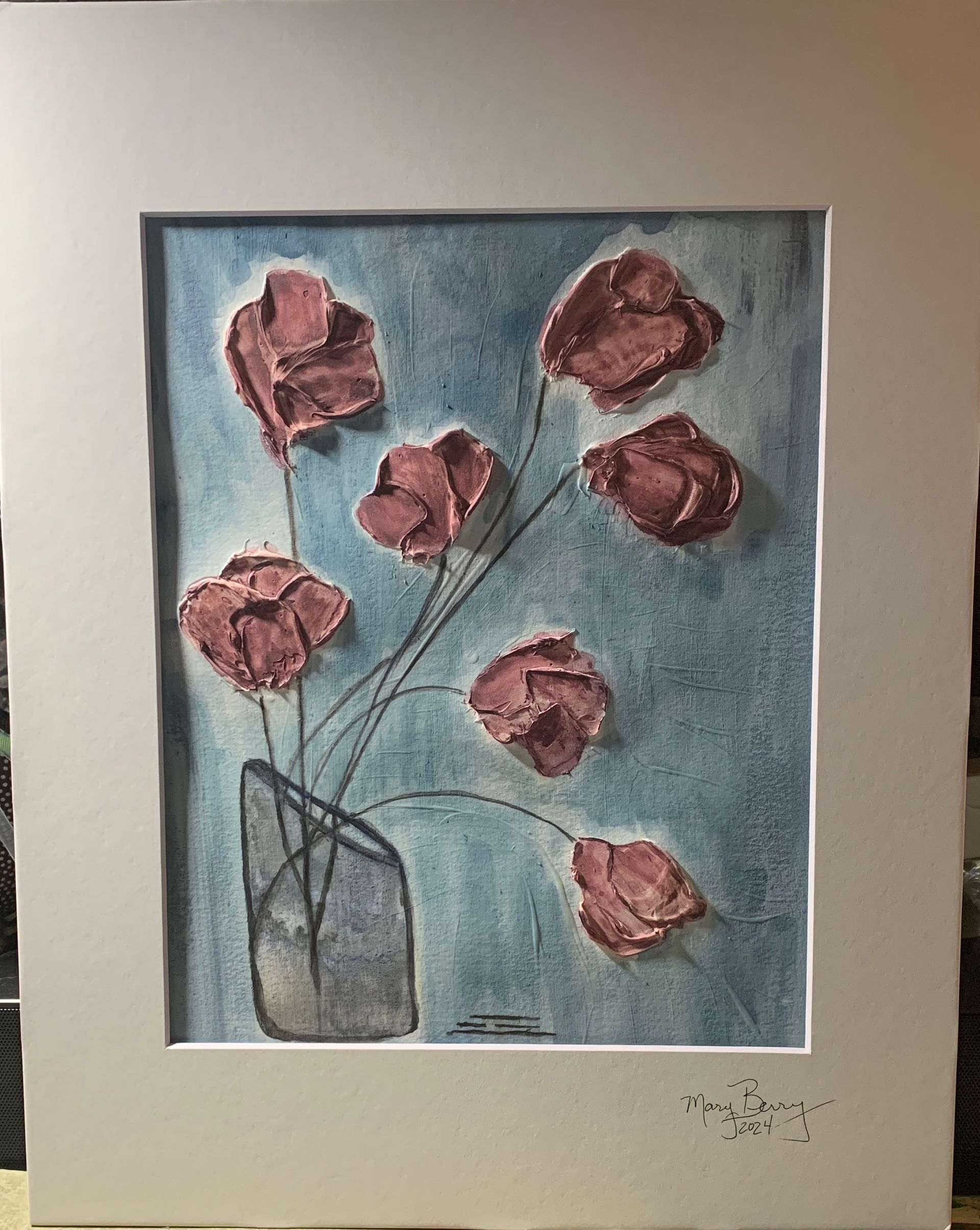 Pink textured flowers in a vase against a blue background, framed by a white mat.  By Mary Berry - Art