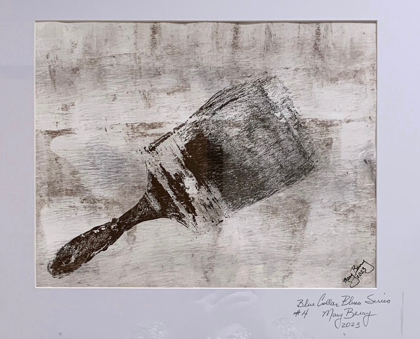 Paintbrush print on a textured white background. Dark brown handle and brush head. Signed and dated.  By Mary Berry - Art
