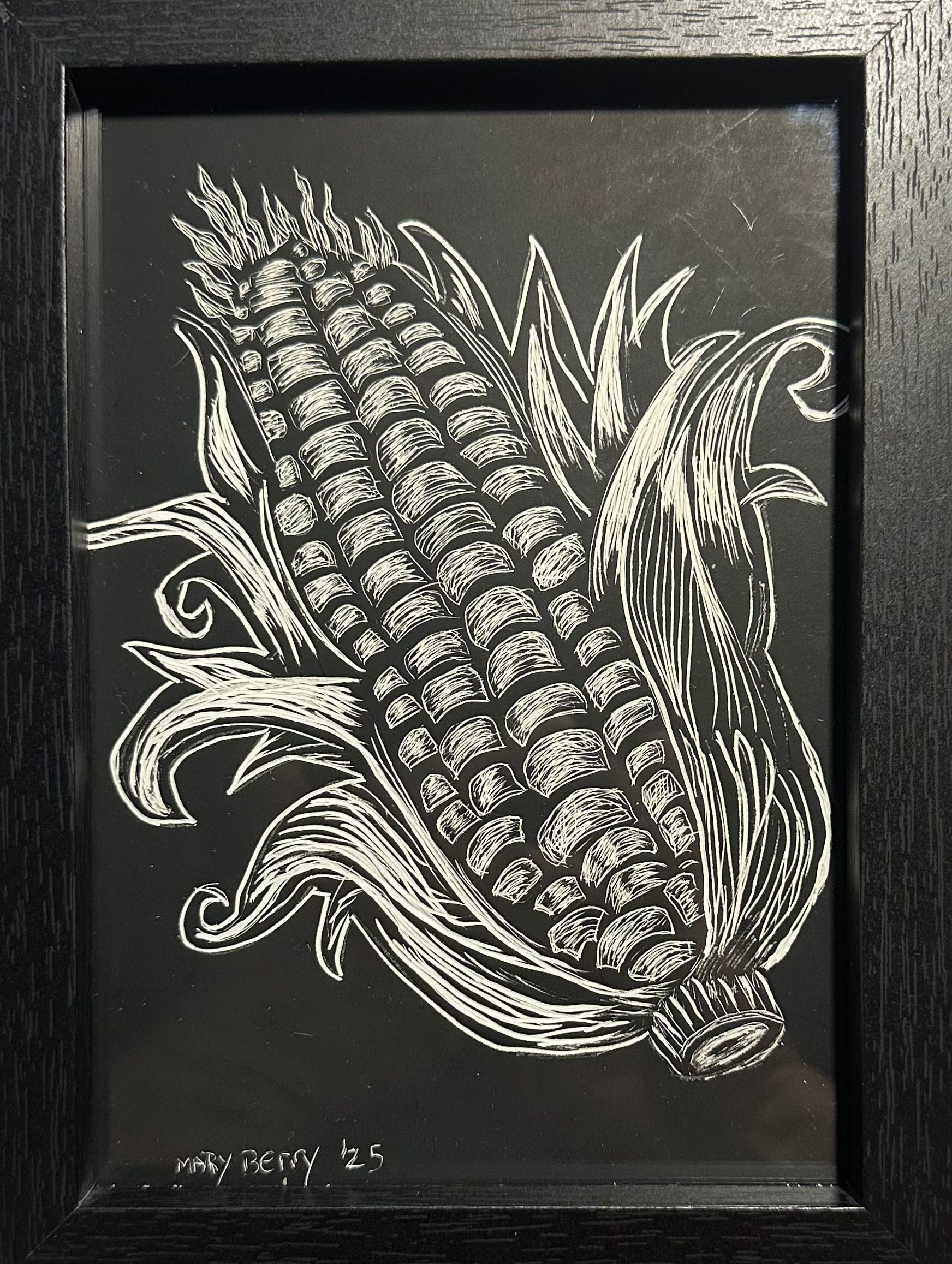 Black and white scratch board of corn on the cob, framed in black.By Mary Berry - Art