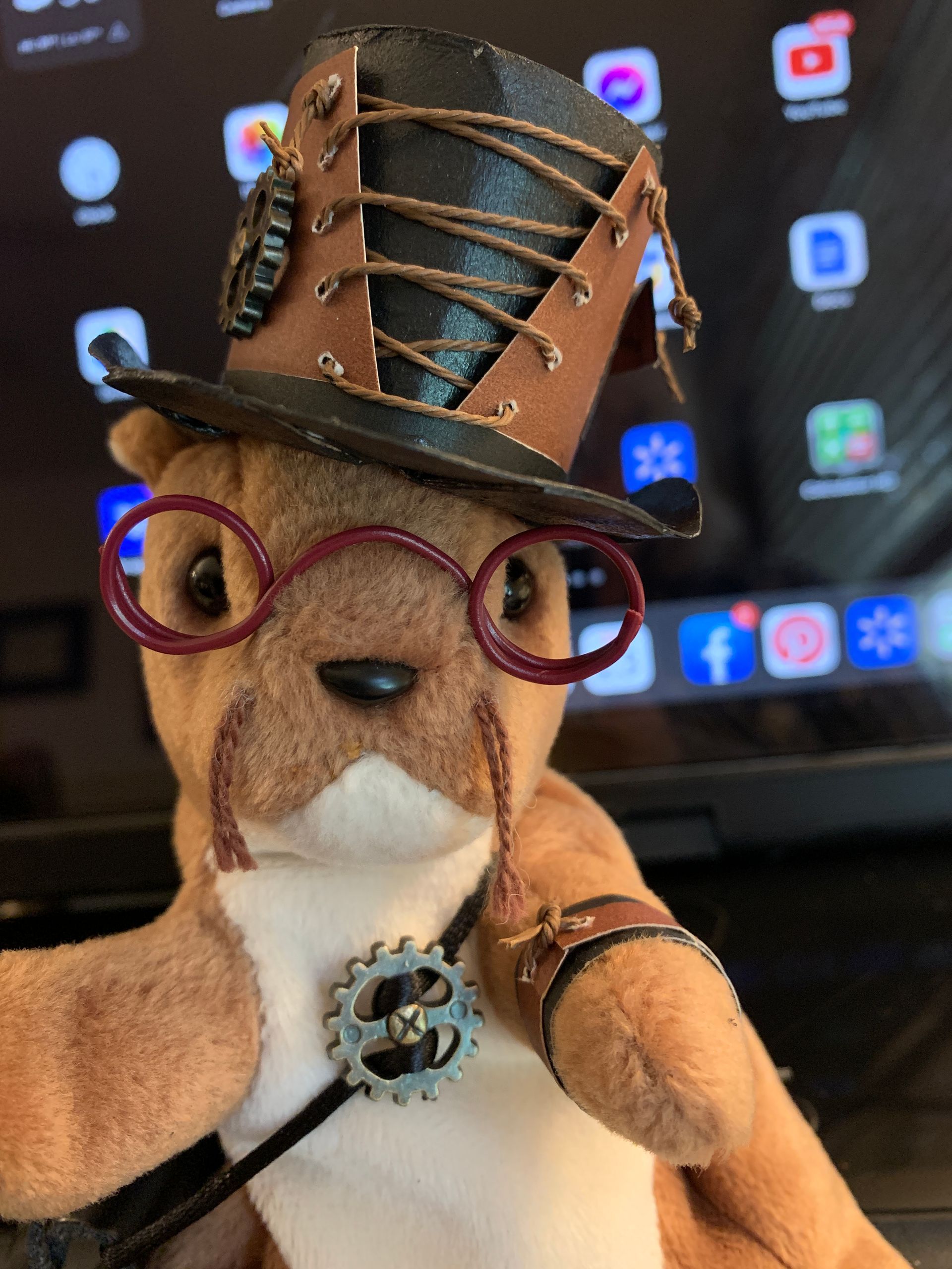 Steampunk squirrel wearing a top hat, round glasses, and cogwheel accessories.  By Mary Berry - Art