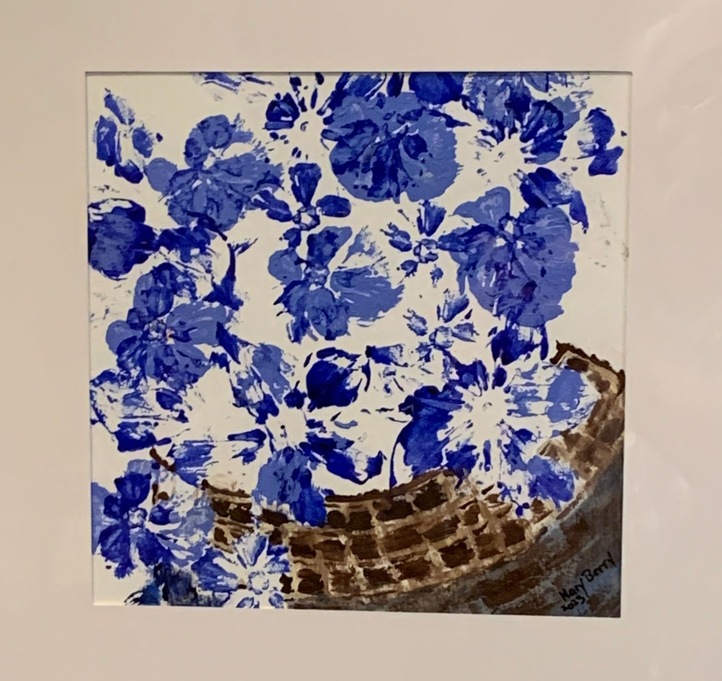 Blue floral painting in a woven basket; blue and brown.  By Mary Berry - Art