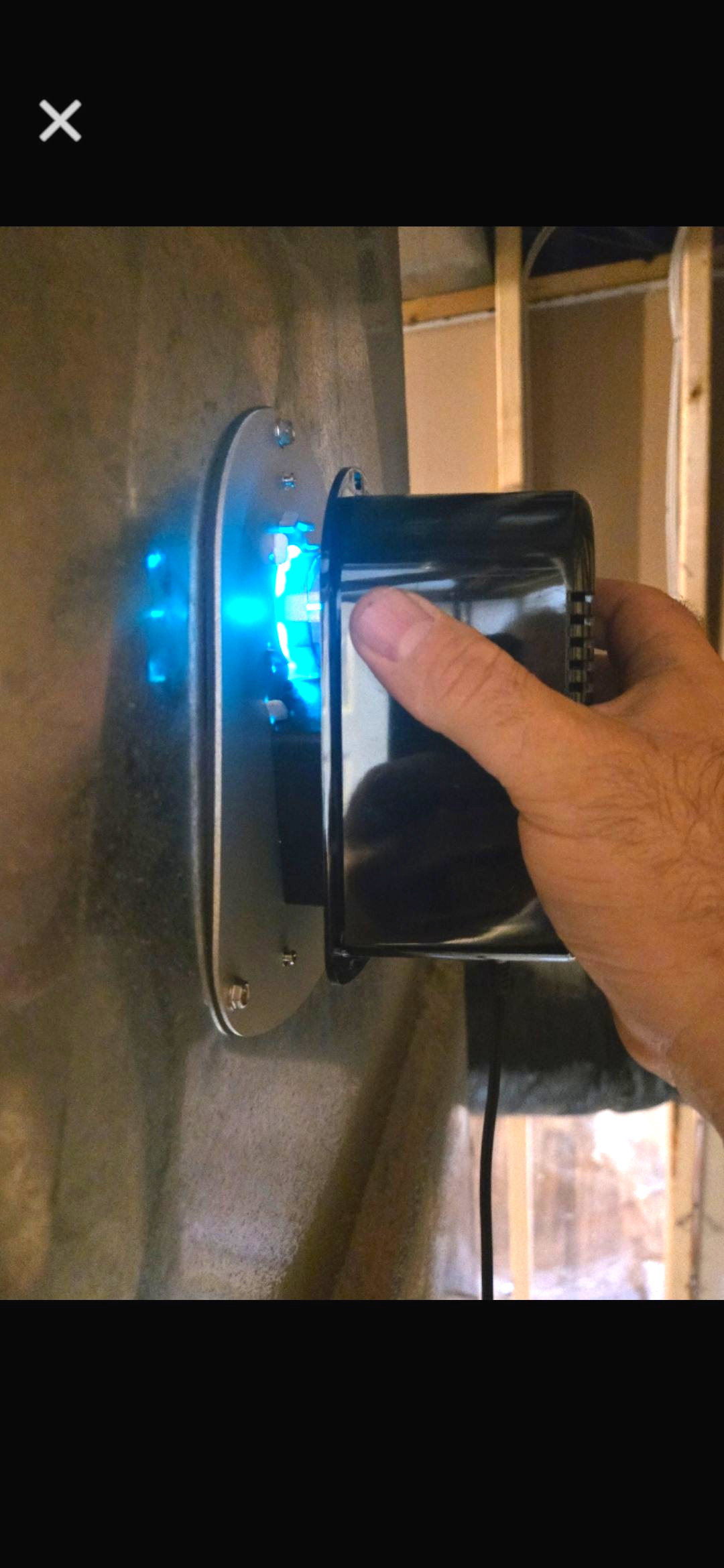 A yellow house with a tree in front of it