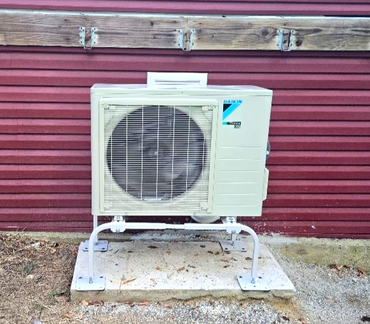 A yellow house with a tree in front of it