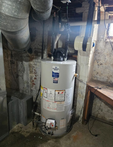 A yellow house with a tree in front of it