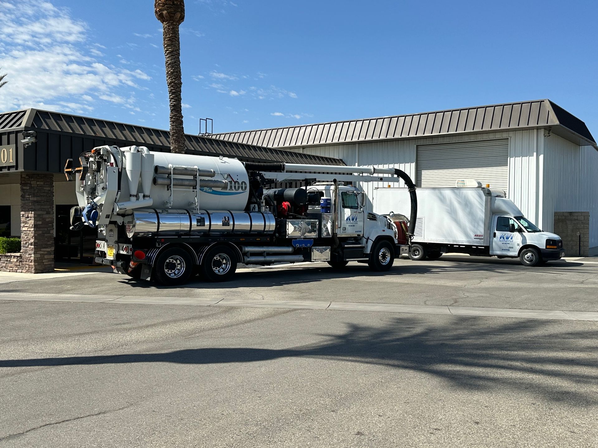 A Hydro Vac truck is parked in front of a building.