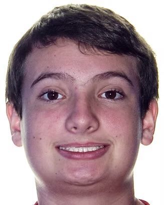 Smiling person with short dark hair, wearing braces, against a white background.