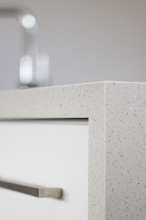 Closer view of the white with black dots quartz surface installed on the storage cabinets