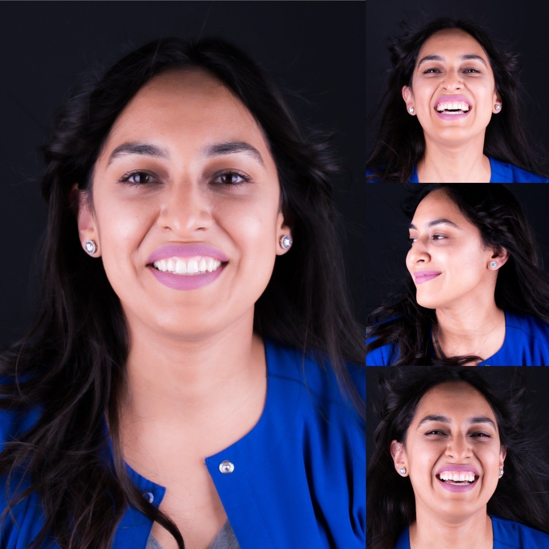 A woman in a blue jacket is smiling for the camera