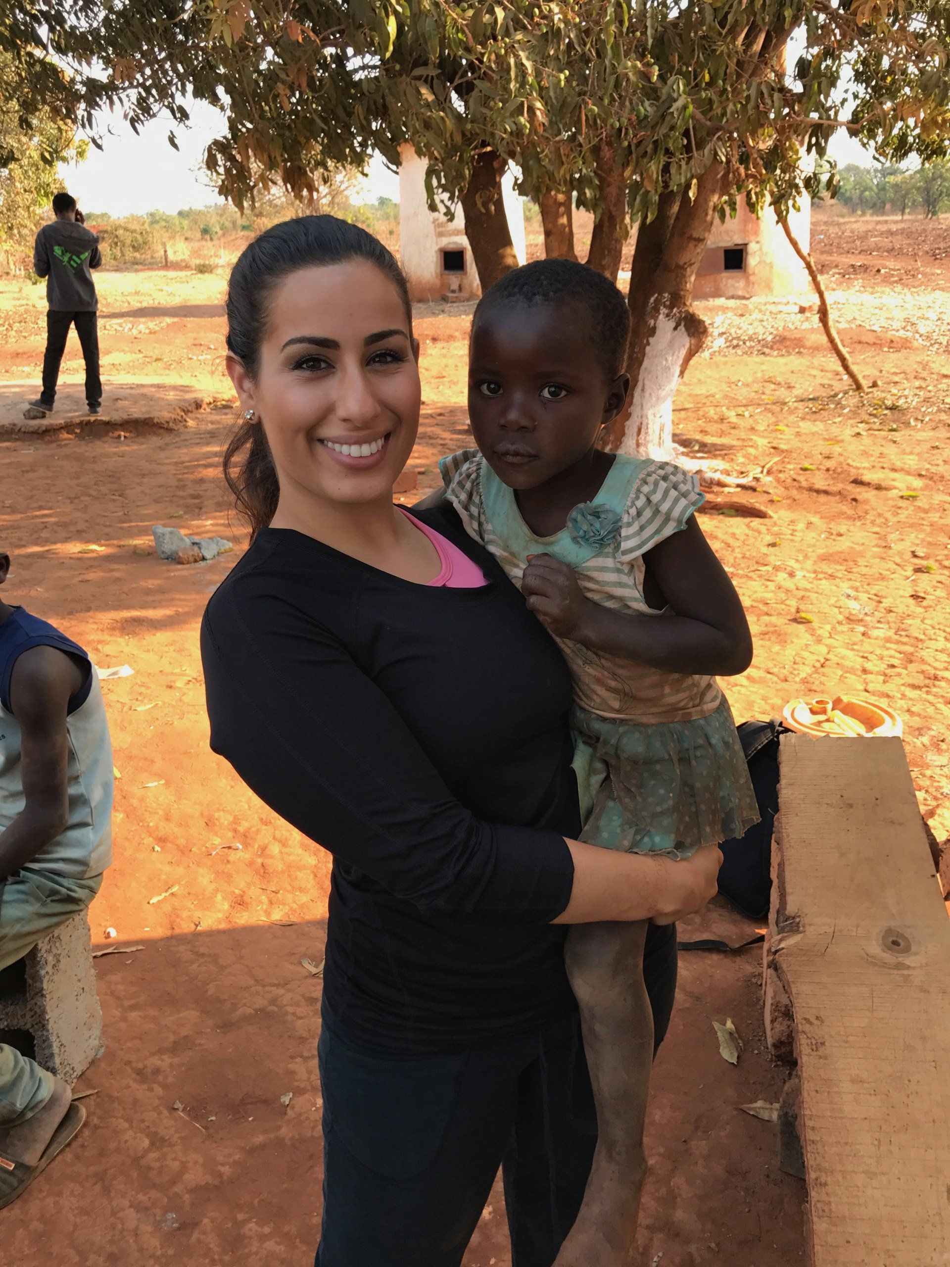 A woman is holding a little girl in her arms.