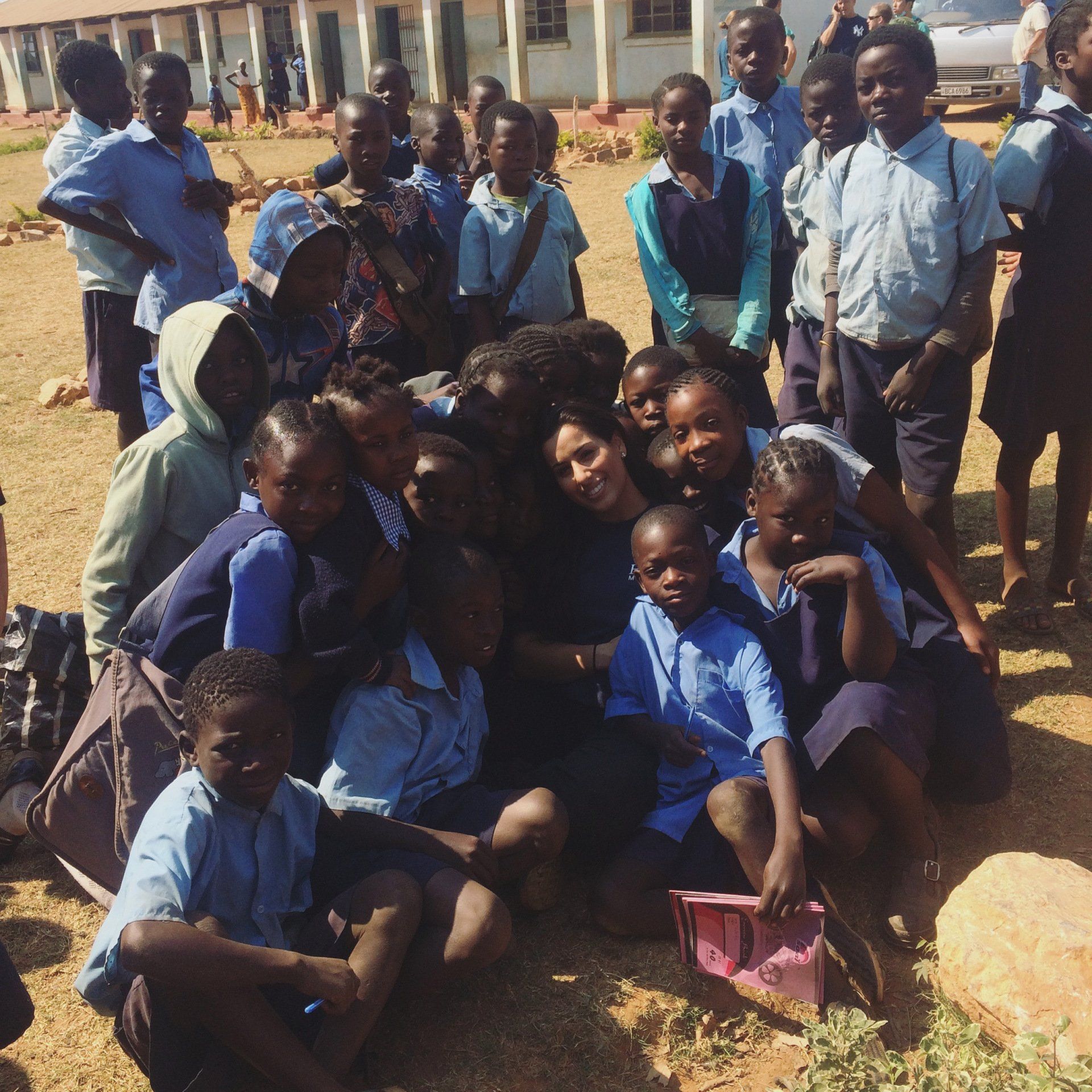 A group of children posing for a picture in a field