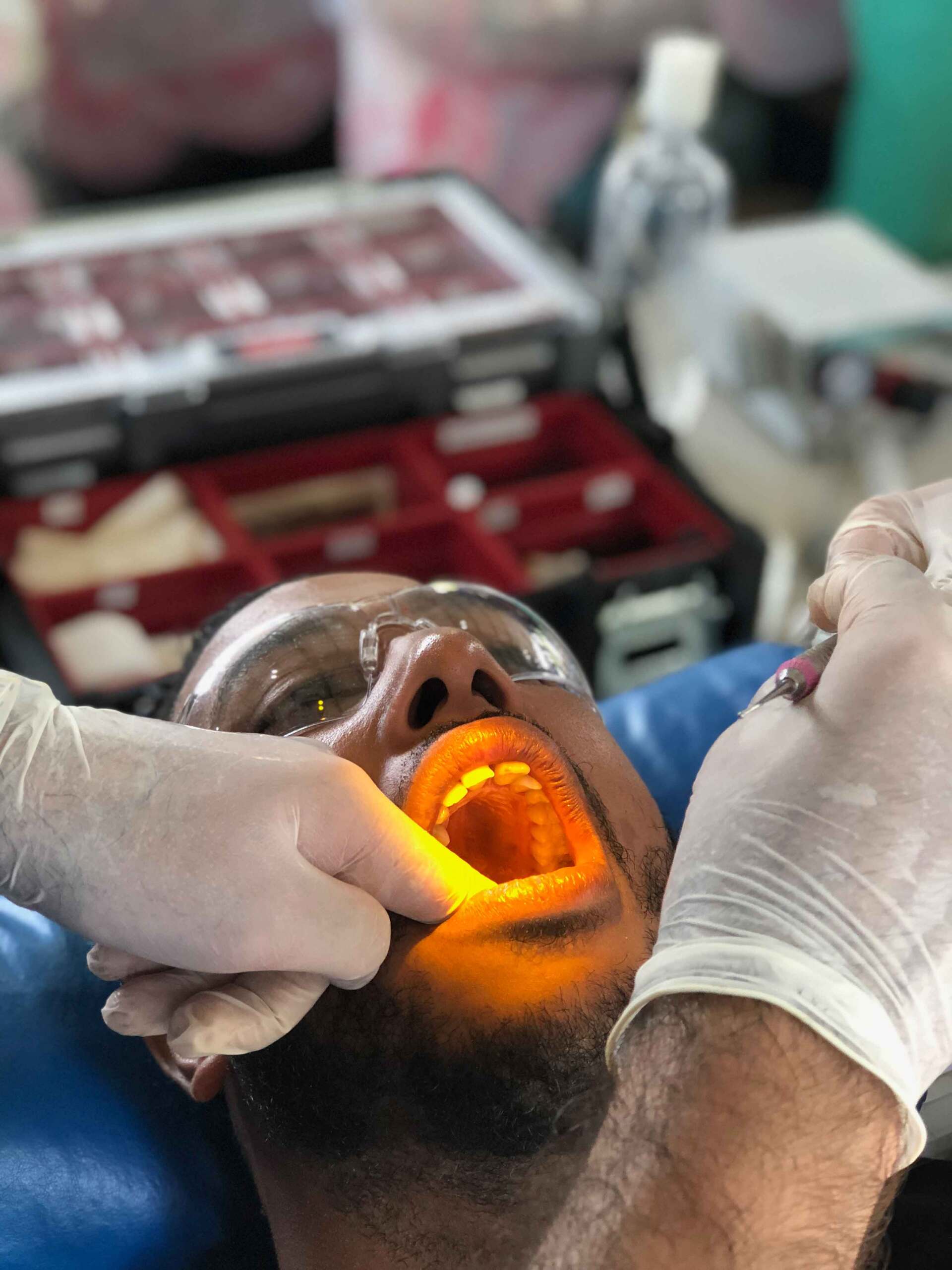 A man is getting his teeth examined by a dentist