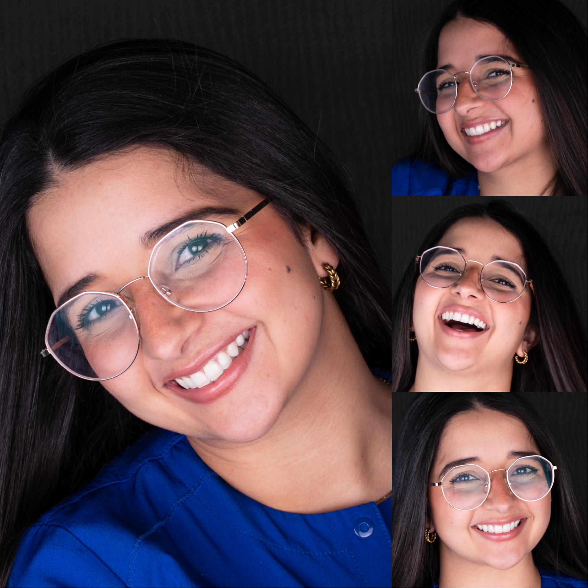 A woman wearing glasses and a blue shirt is smiling