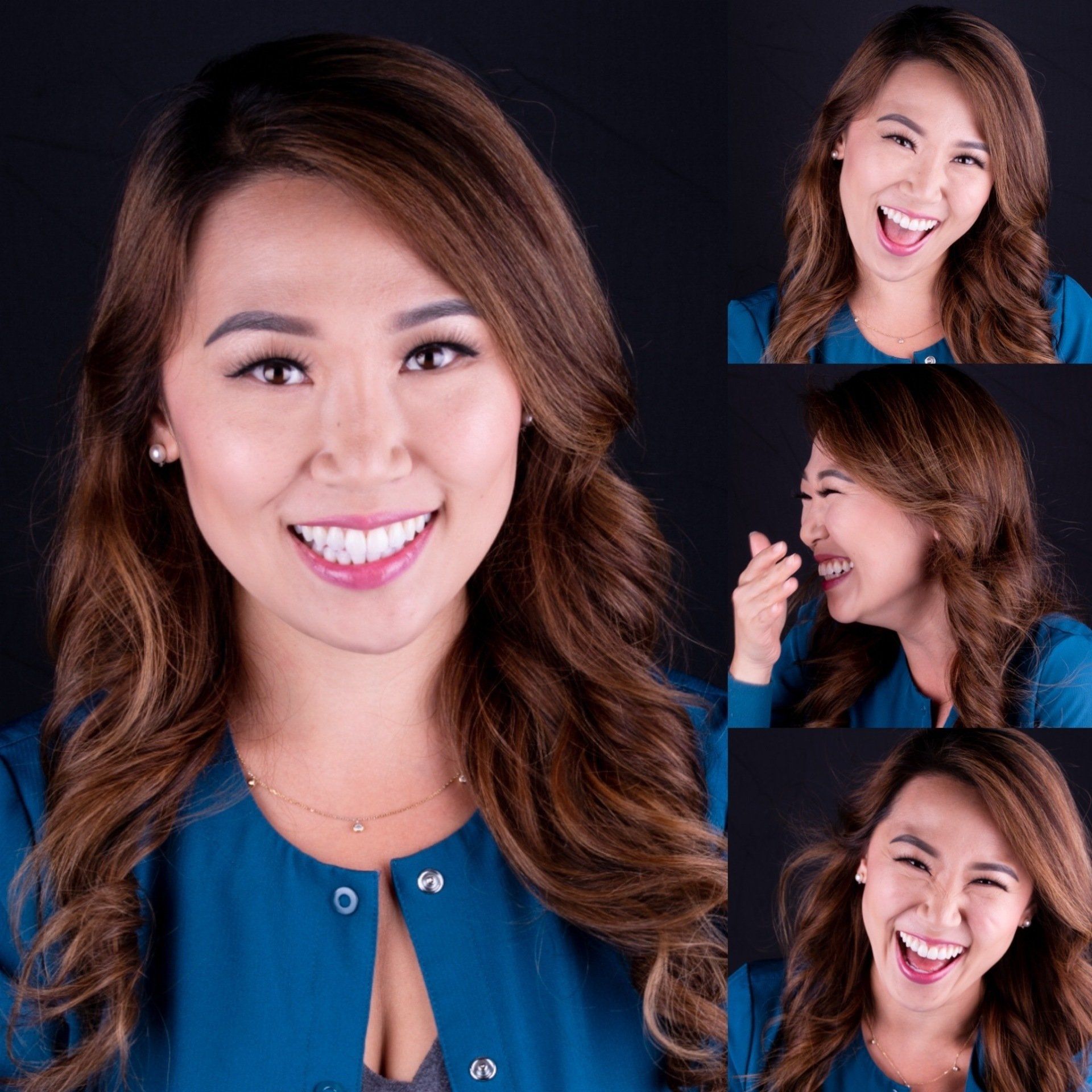 A woman in a blue shirt is smiling and laughing