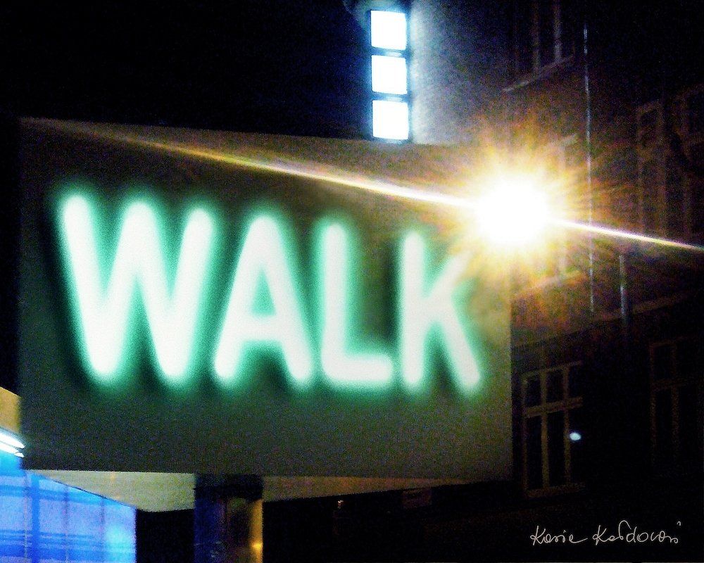 Walk by Kasia Kaldowski — night street scene with glowing green WALK sign, digital artwork.
