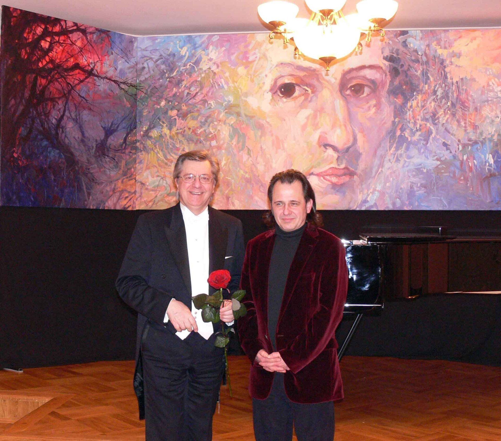 Mariusz Kaldowski and Piotr Paleczny in front of painting of Chopin by Mariusz Kaldowski