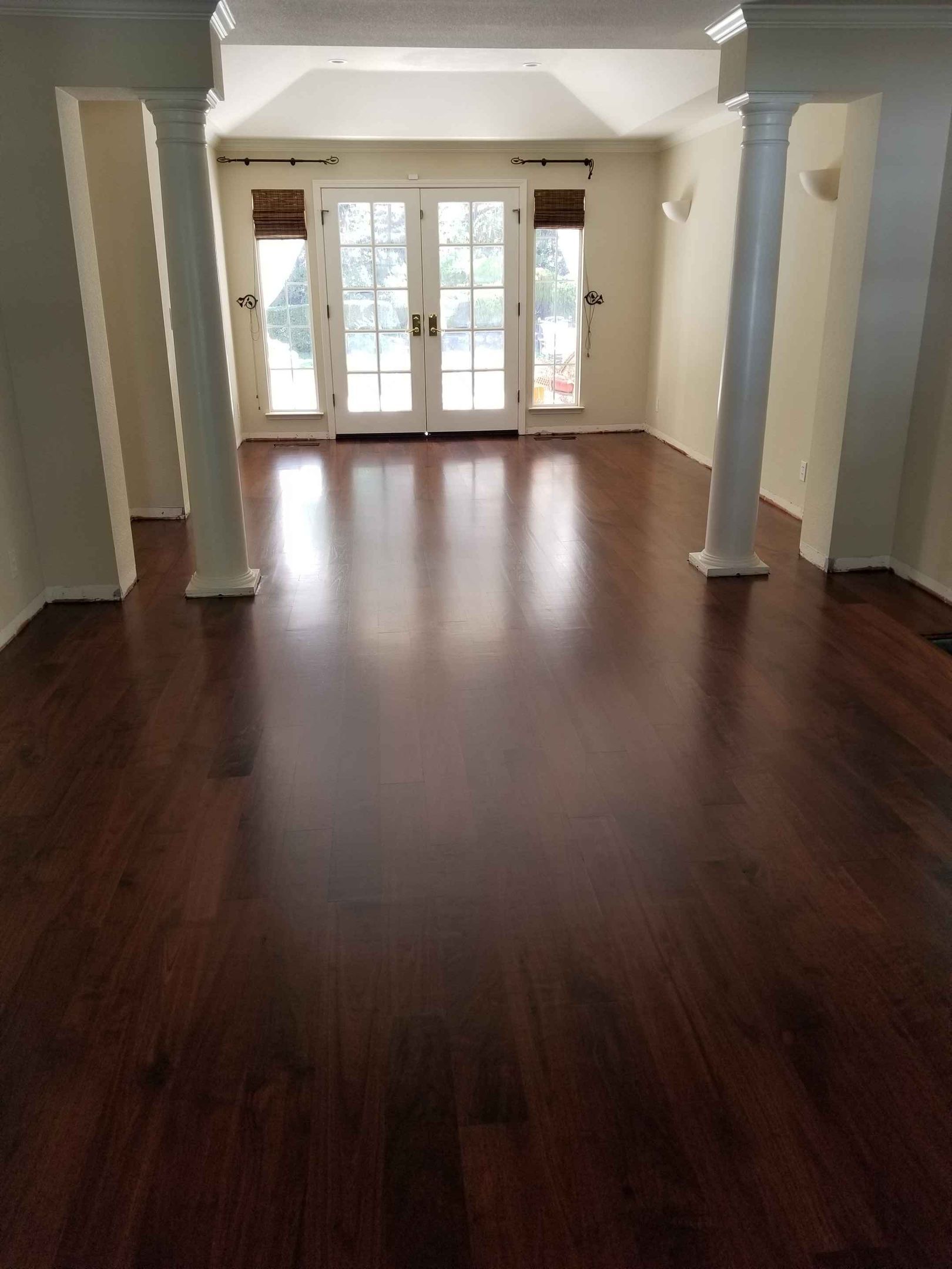Wooden flooring samples in various shades of brown arranged in a fan.