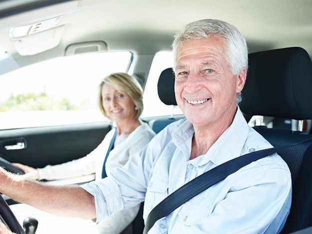 Senior Program — Senior Couple Driving Car in Riverside, CT