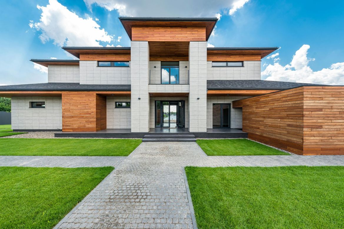 A large modern house with a walkway leading to it.