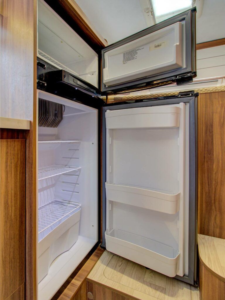 The inside of a moving truck filled with boxes and blankets.