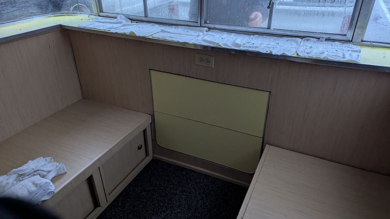 The inside of a moving truck filled with boxes and blankets.