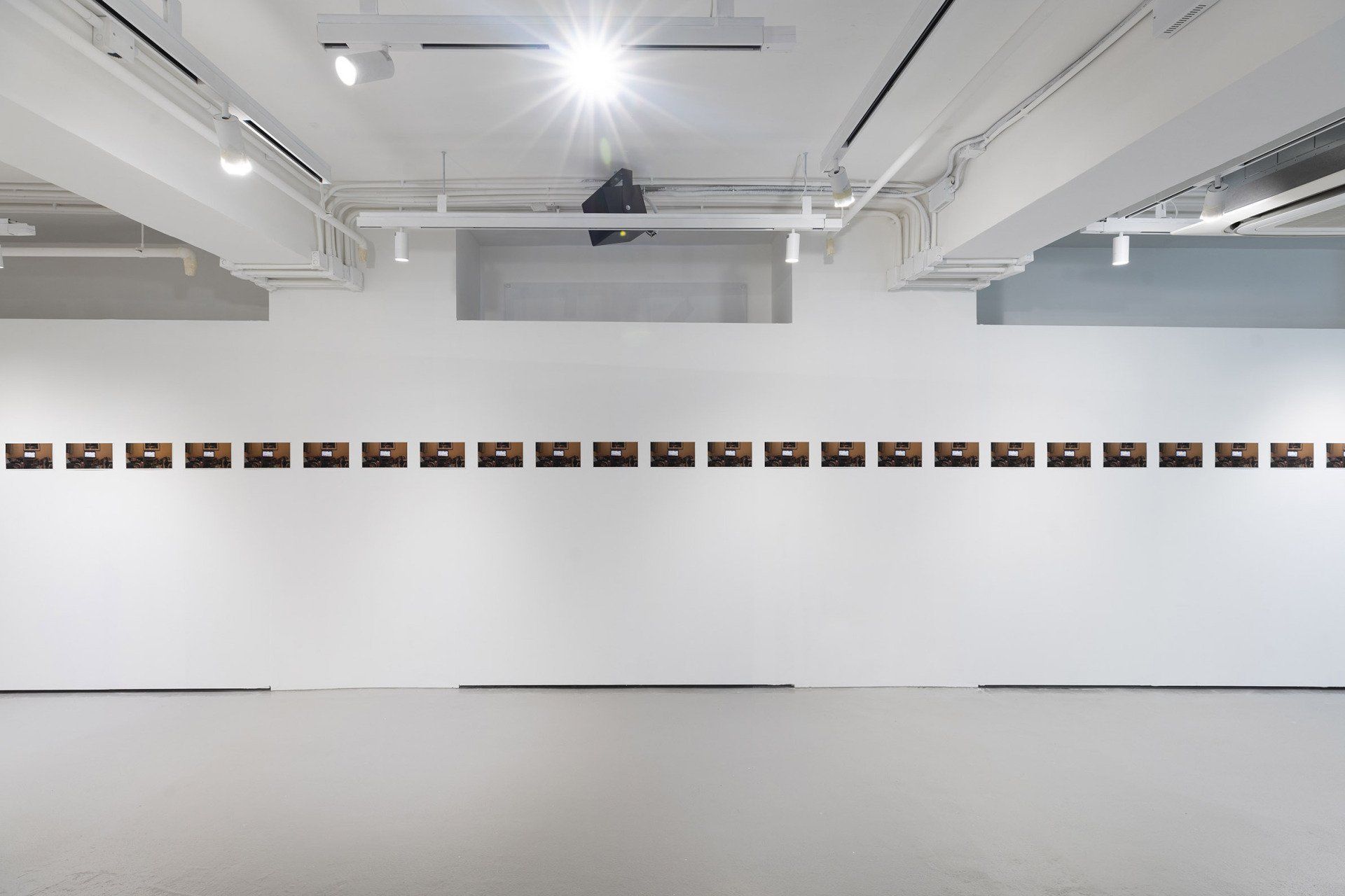 Installation view. Live streaming, Prince Edward, 12/11/2019, 23:35:05-6. 25 frames per second, 1920x1080. 2019. 14.06x25cm. 25 Archival pigment prints. Photograph courtesy WMA Space