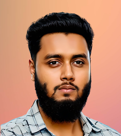 Suleman Ahmed  wearing a plaid shirt and sporting a well trimmed beard