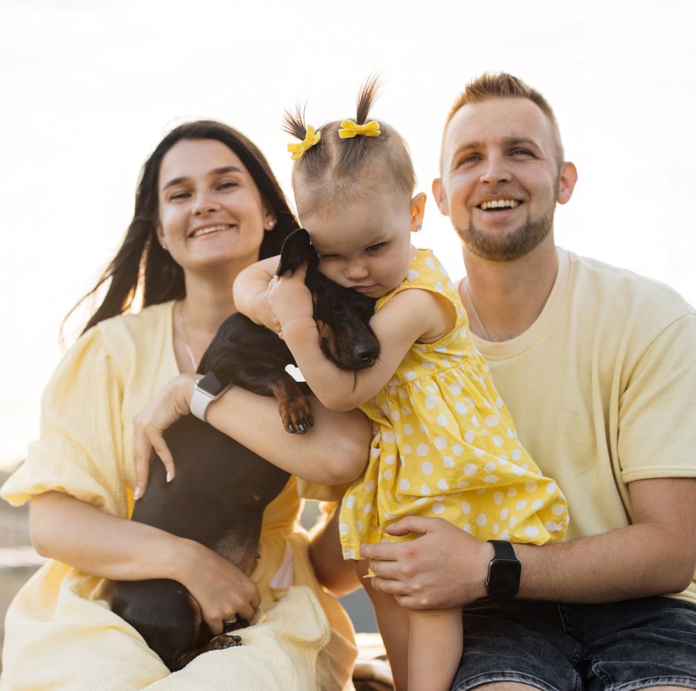 A white house with a blue roof is reflected in the water.