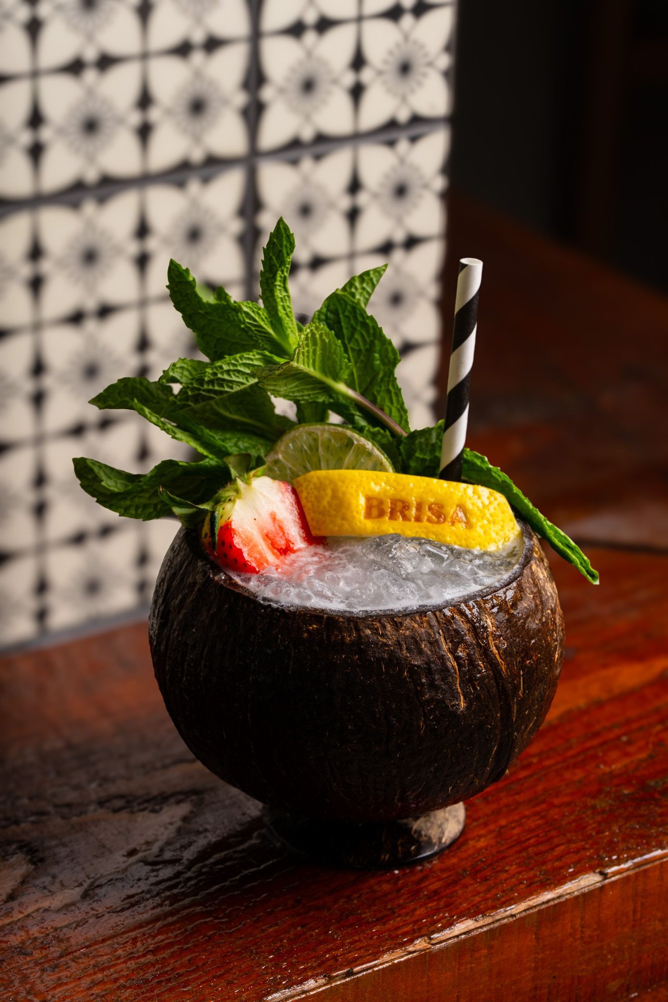 Coconut cocktail with mint garnish in coconut glass