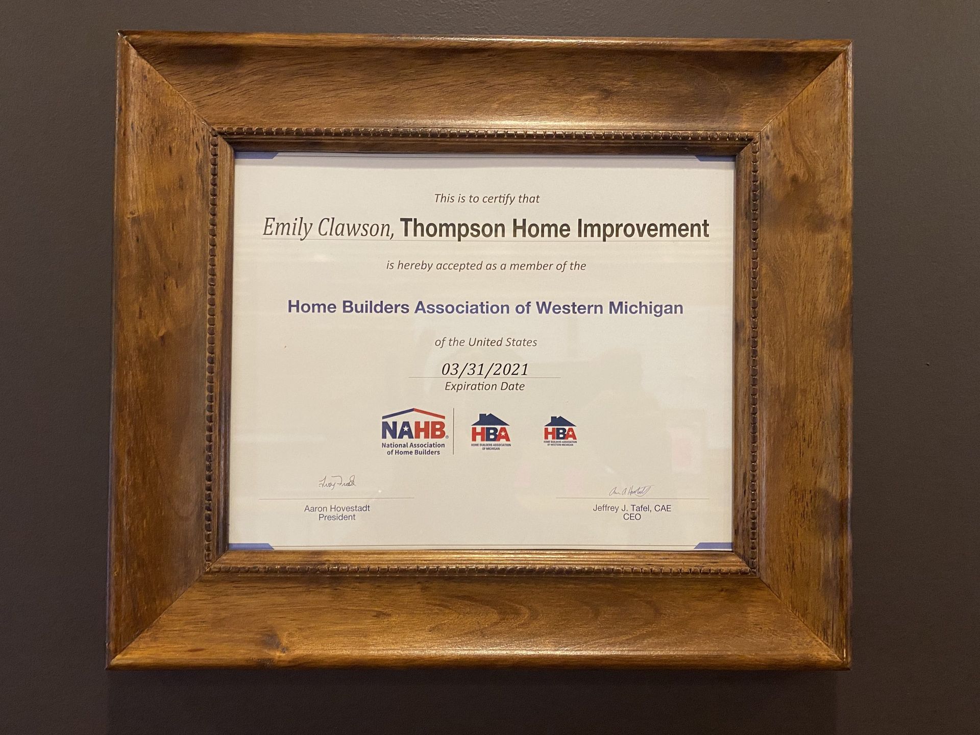 A framed membership certificate for Thompson Home Improvement from the Home Builders Association of Western Michigan.