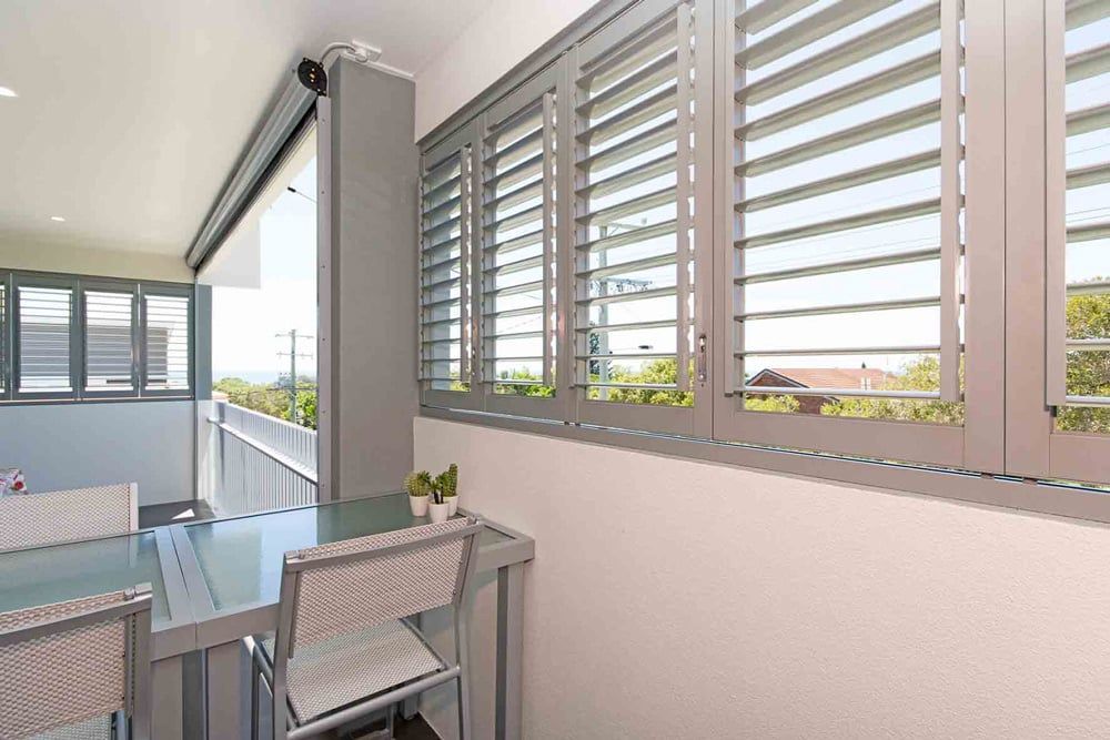 A Balcony And Shutters On The Windows — Balcony Shutters Australia In Moffat Beach, QLD
