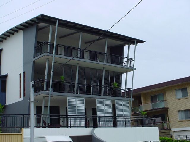 A Building With A Lot Of Balconies And Shutters — Balcony Shutters Australia In Moffat Beach, QLD