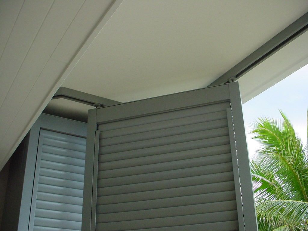 A Window With Shutters On It And Palm Trees In The Background — Balcony Shutters Australia In Moffat Beach, QLD