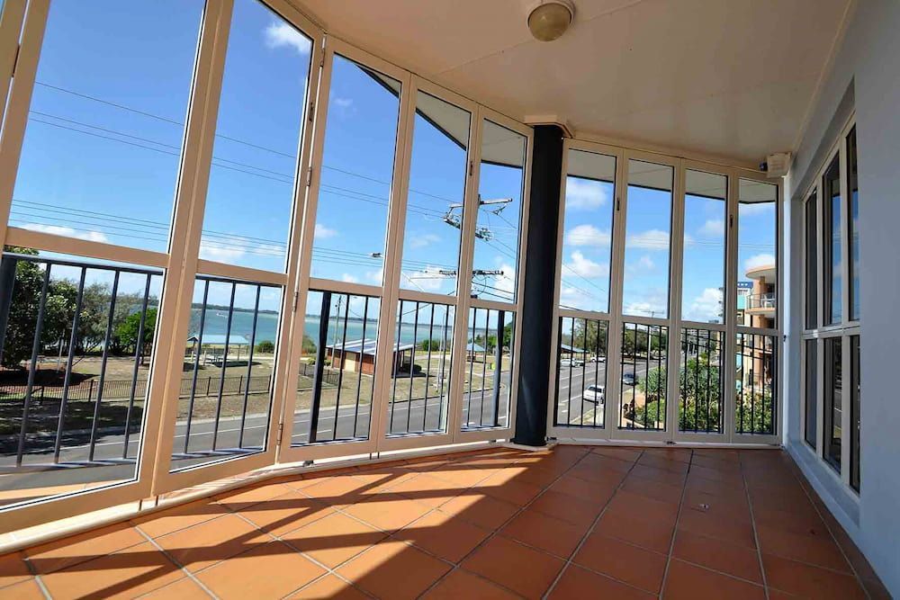 An Empty Room With A Balcony And Lots Of Windows — Balcony Shutters Australia In Moffat Beach, QLD